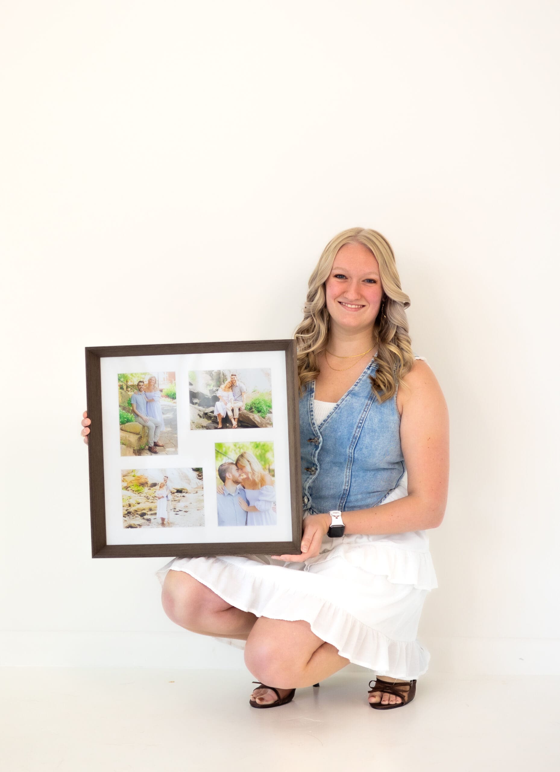 Amber the photographer holding framed collage of couple in Greenville SC