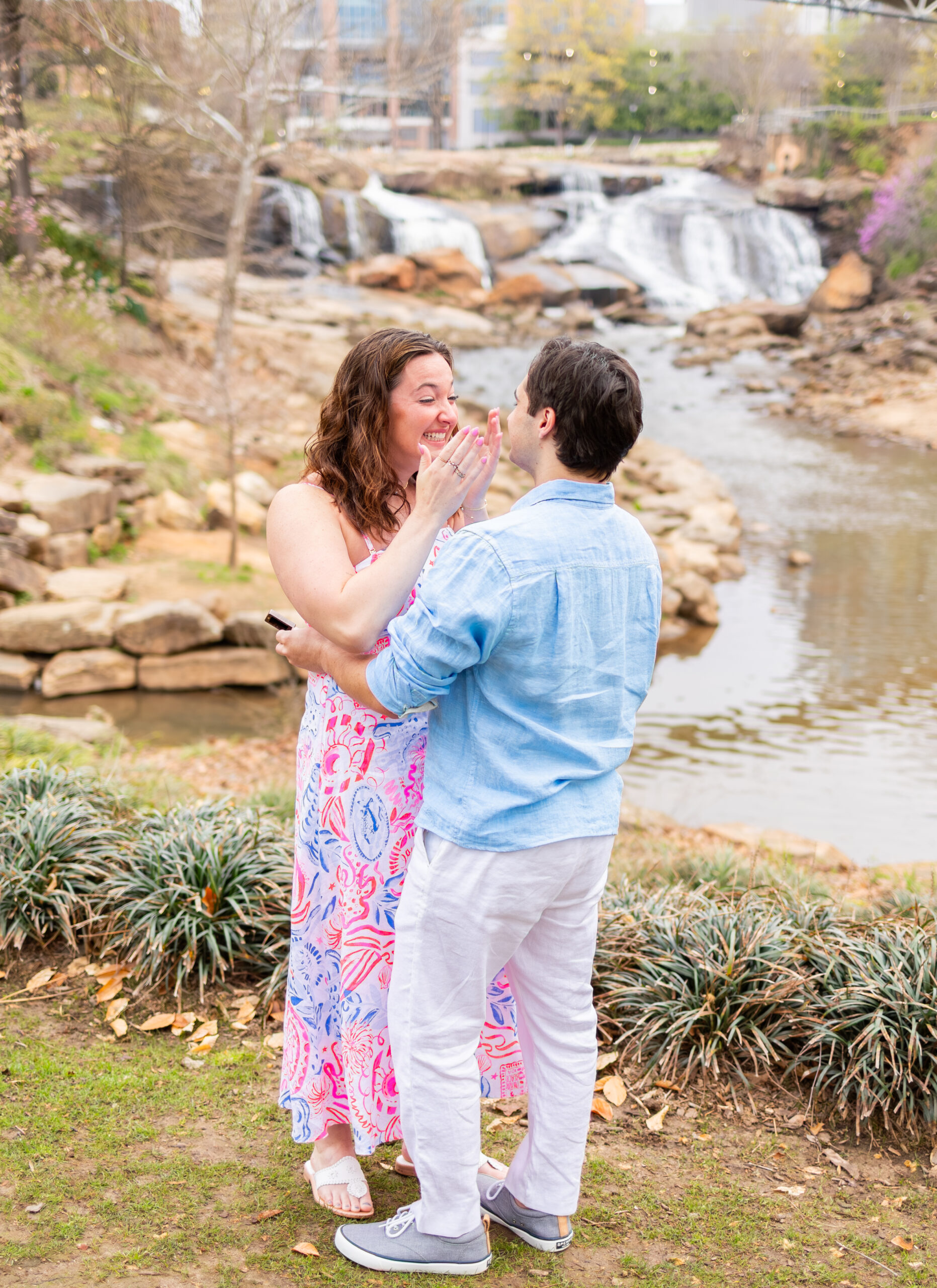 girl emotional to proposal in front of river in downtown greenville
